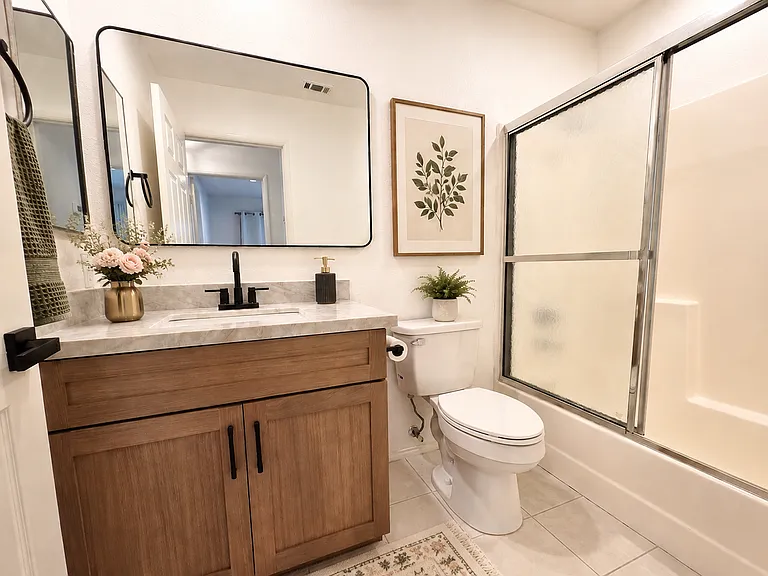 New bathroom vanity. Furnished photos are virtually staged for reference. No furnishings are included with lease.