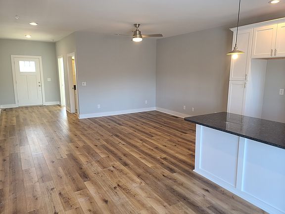 Front door, dining area and kitchen island. Hardwood throughout downstairs.
