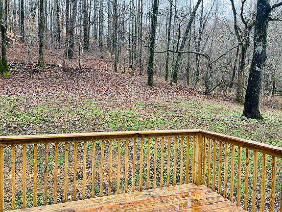Deck on back looking out toward a wooded area.