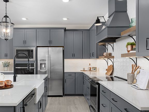 Kitchen with floating shelves and gorgeous vent-hood