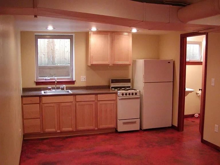 Kitchen now has more upper cabinets, a dishwasher, full size electric range and a stove hood that vents directly outside