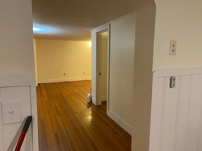 Leaving dining room. Door on right is entrance to bedroom.