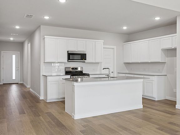 Kitchen in the Masters home plan by Trophy Signature Homes - REPRESENTATIVE PHOTO