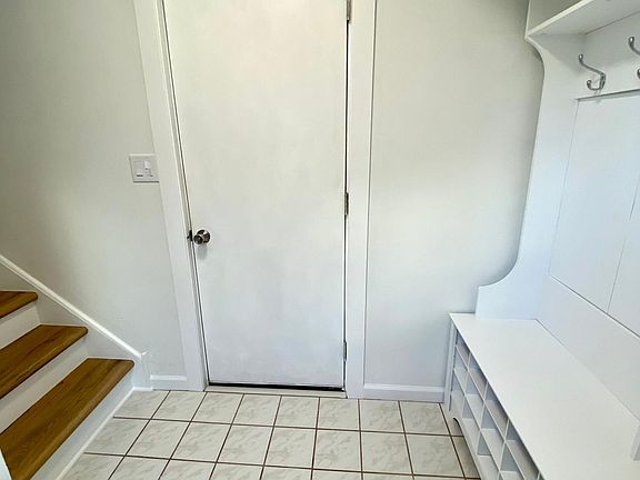 Entryway includes a hall tree with a bench and shoe & coat storage.