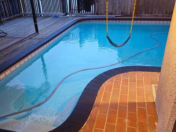 Large partially covered pool and adjacent deck.