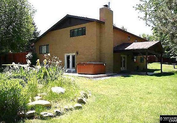 Large landscaped yard with hot tub