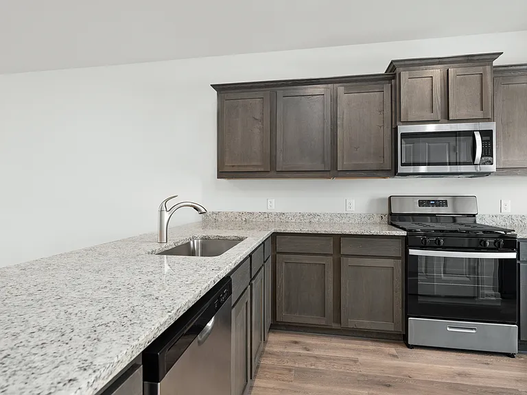 The kitchen has plenty of cabinet space for storage.