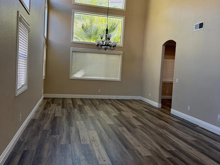 Entry room with high ceilings. New flooring throughout the house.