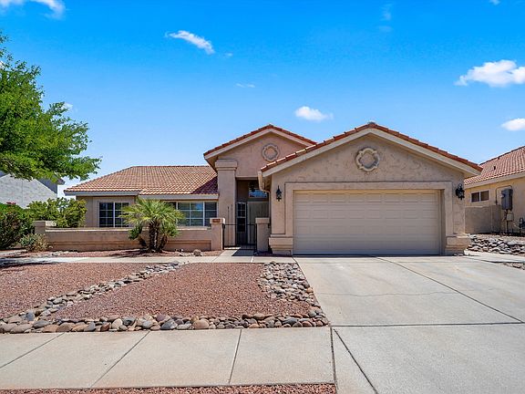 Amazing curb appeal! Tiled roof, wrought iron security screen, 2-car garage, fresh decorative rock and low-care landscaping