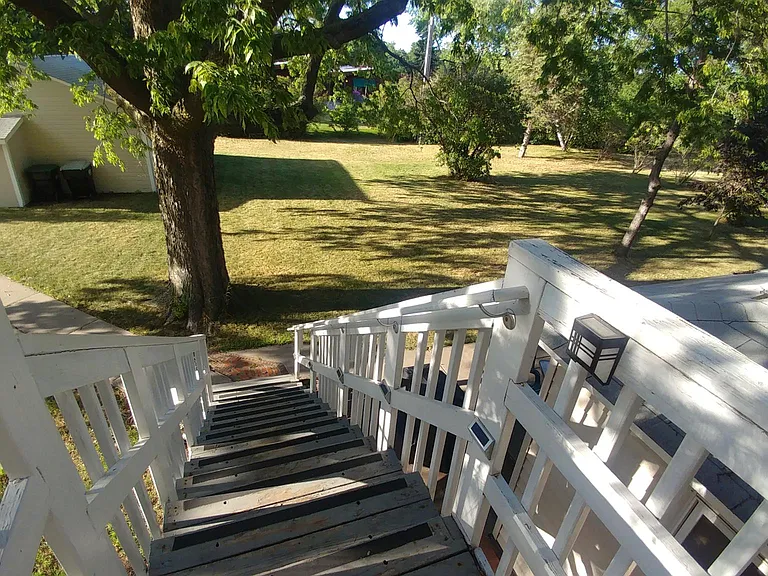 Steps to your door and view of backyard and mature oak tree