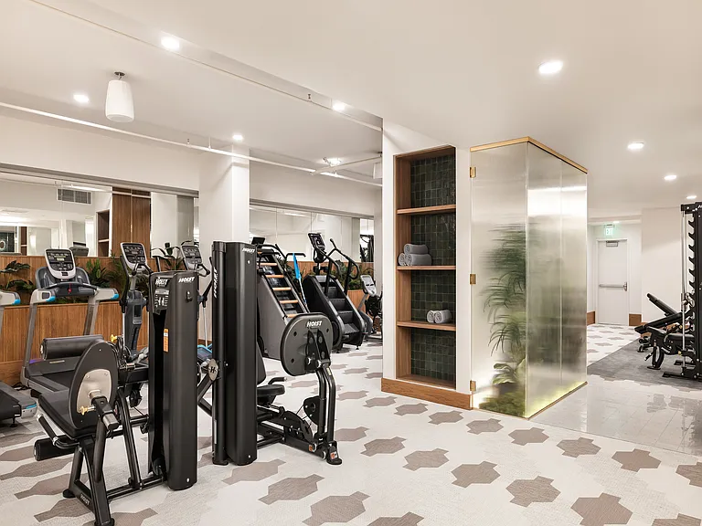 Modern fitness center with state-of-the-art equipment, sleek mirrored walls, and stylish lighting for an invigorating workout experience.