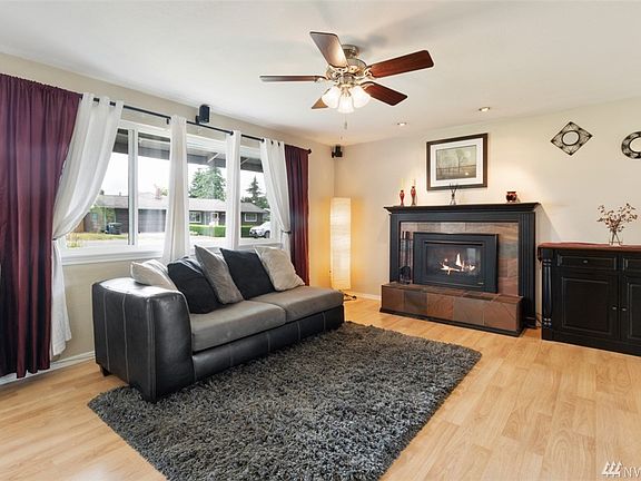 Light filled living room with cozy gas fireplace.