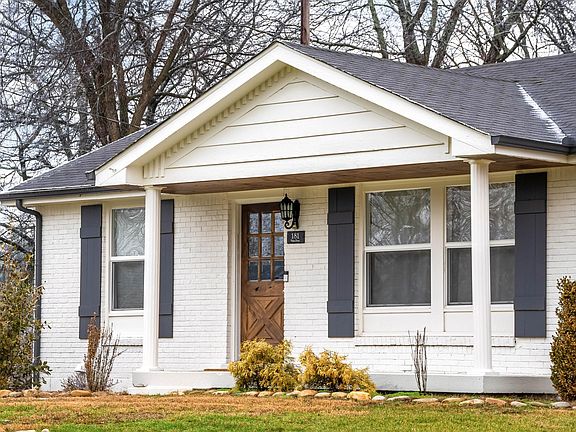 Very welcoming front porch, love the front door design.