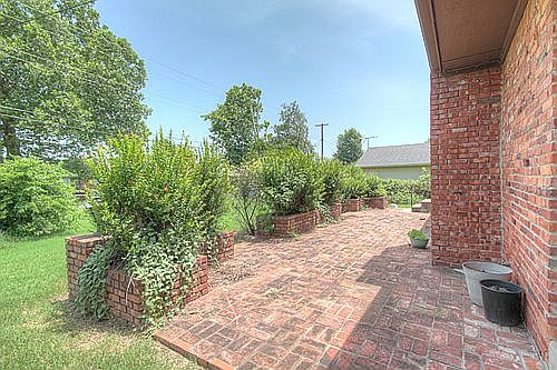 Brick patio will accommodate full size outdoor furniture.