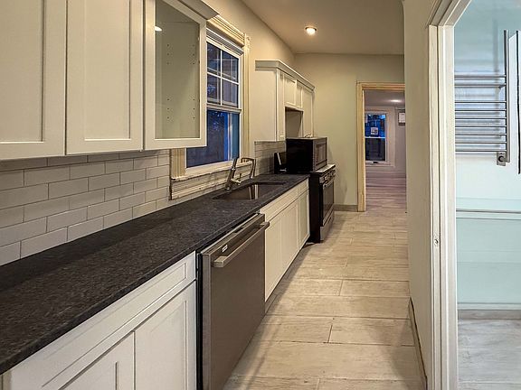 Kitchen cabinets with dishwasher and granite counters