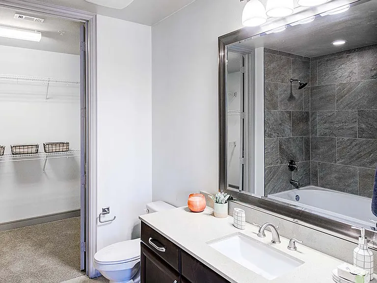 Griffis Uptown apartment bathroom with closet door.
