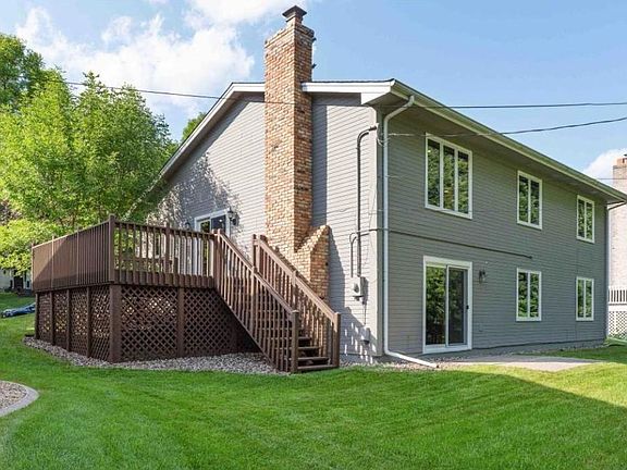 Back of home with privacy and big deck to backyard