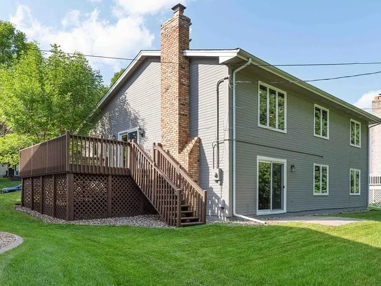 Back of home with privacy and big deck to backyard