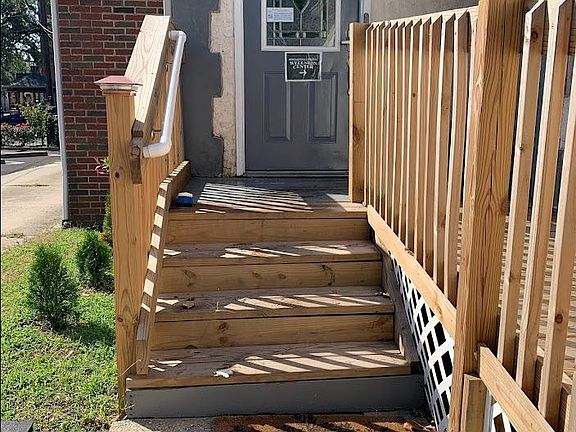 Off street entrance with security camera, lighting, and security code.