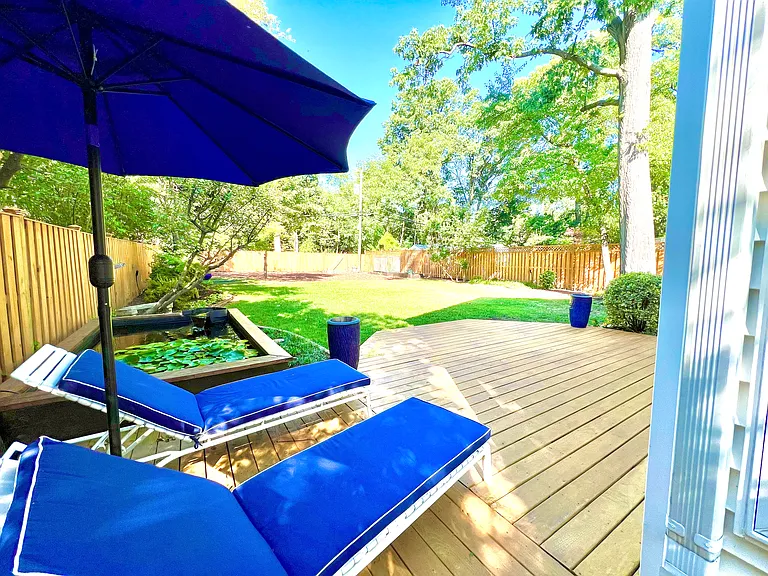 Backyard. Chairs and umbrella will remain for you to enjoy