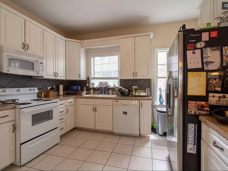 Modern, spacious kitchen. Fridge, electric stove, dishwasher, disposal, and built-in microwave.