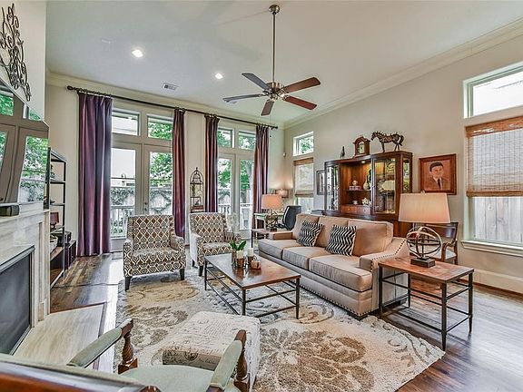 Living area has an abundance of natural light from oversized windows and french doors that lead to private deck and backyard.