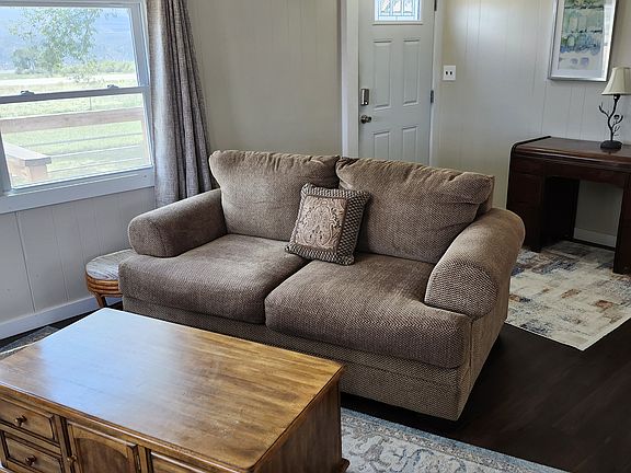 Front door behind living room couch
