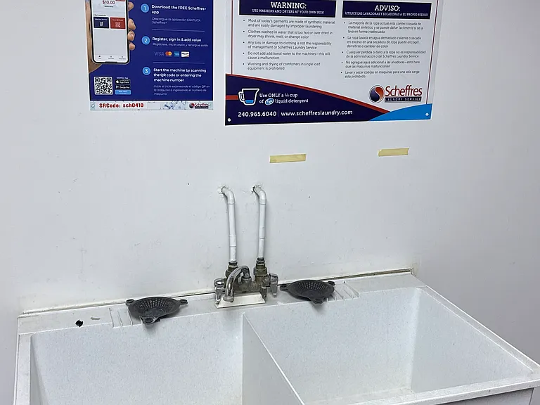 shared sink in laundry room, app-instructions for laundry machines on wall