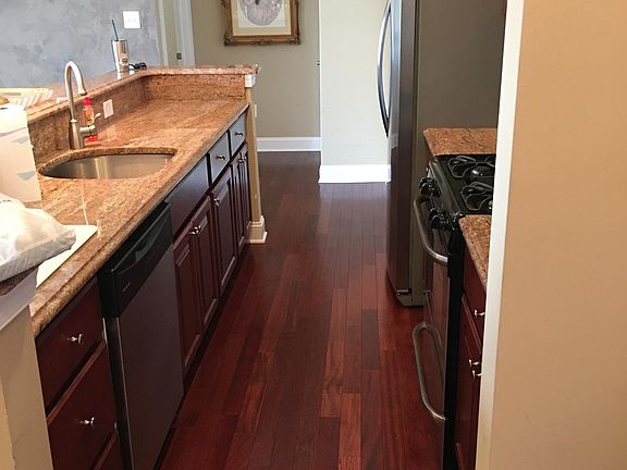 Galley Kitchen with hardwood floors 