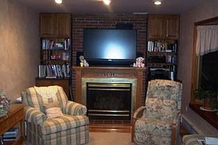 Family room w/gas fireplace & bow window overlooking back yard.