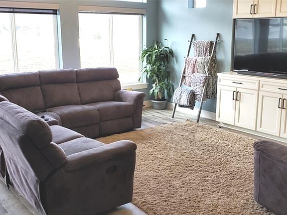 Open concept kitchen/dining/living area with tons of natural light!