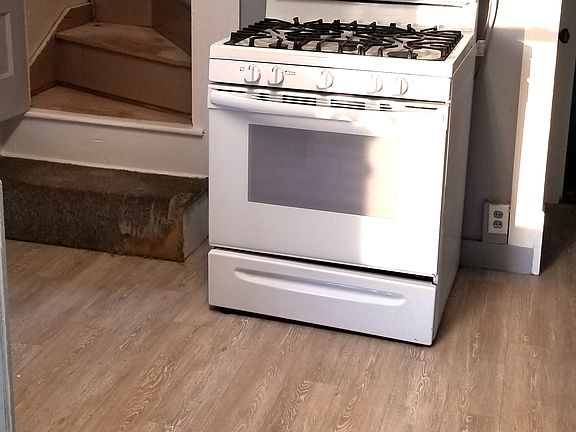 Kitchen with gas stove and wood flooring