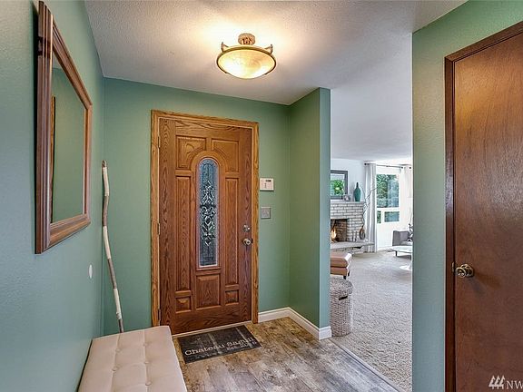 The formal entry with Luxury vinyl plank floors features a coat closet and room for a bench