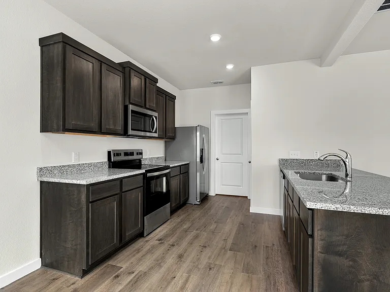 The kitchen has beautiful wood cabinetry.