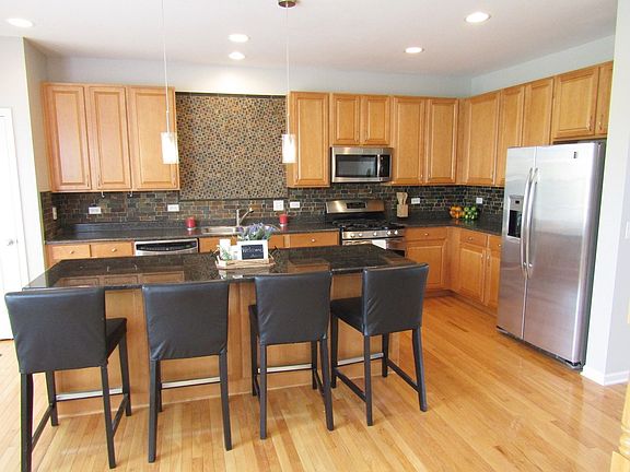 Custom-Made Breakfast Island with Granite Countertop.  Comfortably sits four.