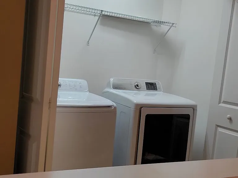 The washer and drier are located in the third-floor hallway, providing a convenient laundry experience.