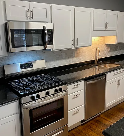 Recently remodeled kitchen with stainless appliances, including stove, microwave, refrigerator and dishwasher