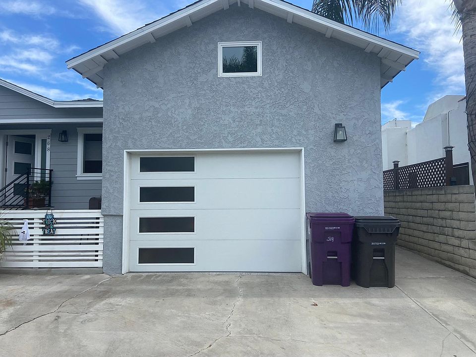 Front of house with sidewalk on right to back units.