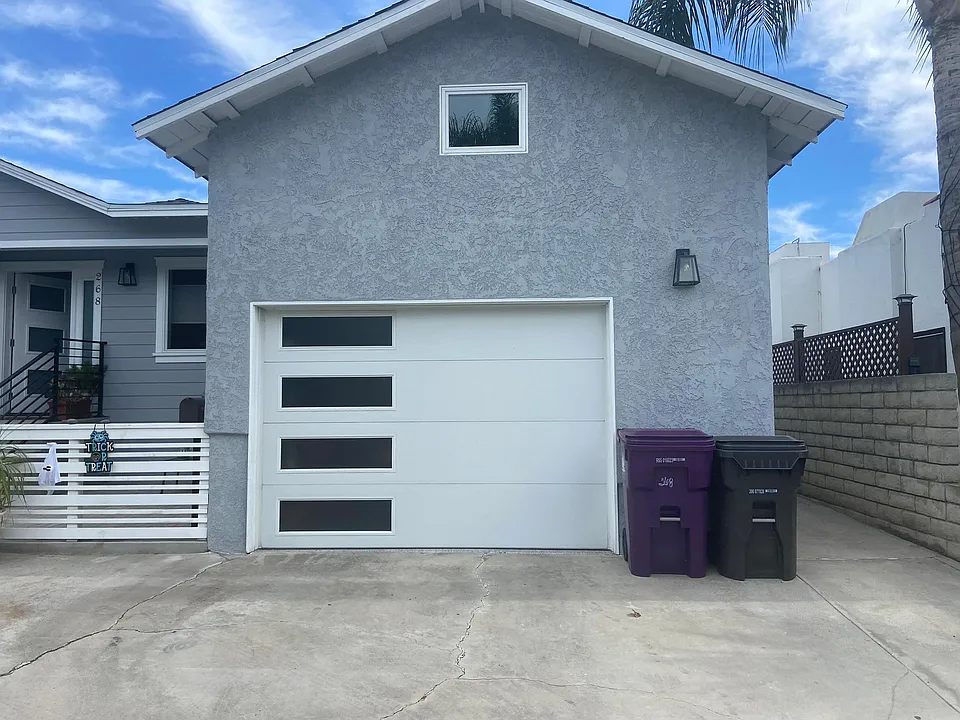 Front of house with sidewalk on right to back units.