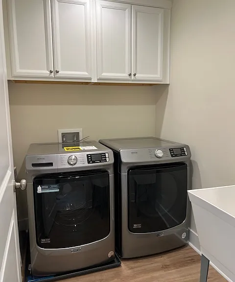 Laundry room - Front load machines, cabinets and separate sink