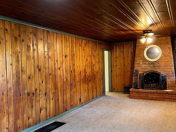 Living room with wood burning fireplace.
