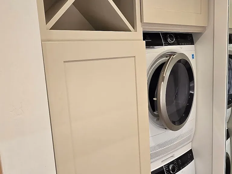 Wine rack, storage cabinet above washer/dryer, panel to hide hot water heater