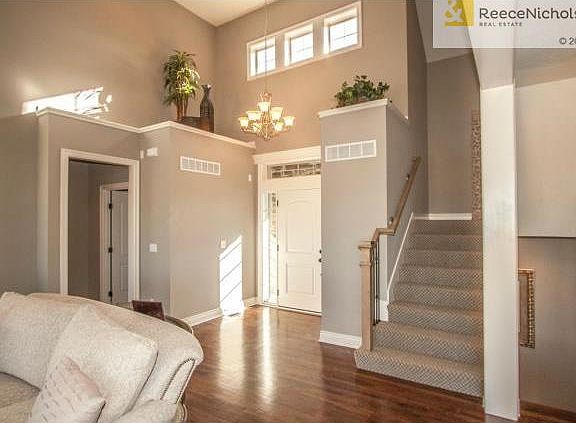 STAIRWAY TO 2ND LEVEL, TO BASEMENT AND ENTRANCE