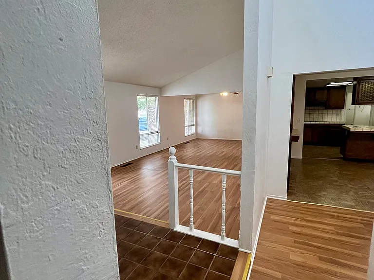 Entryway, hallway , living, dinning rooms. Kitchen in the background.