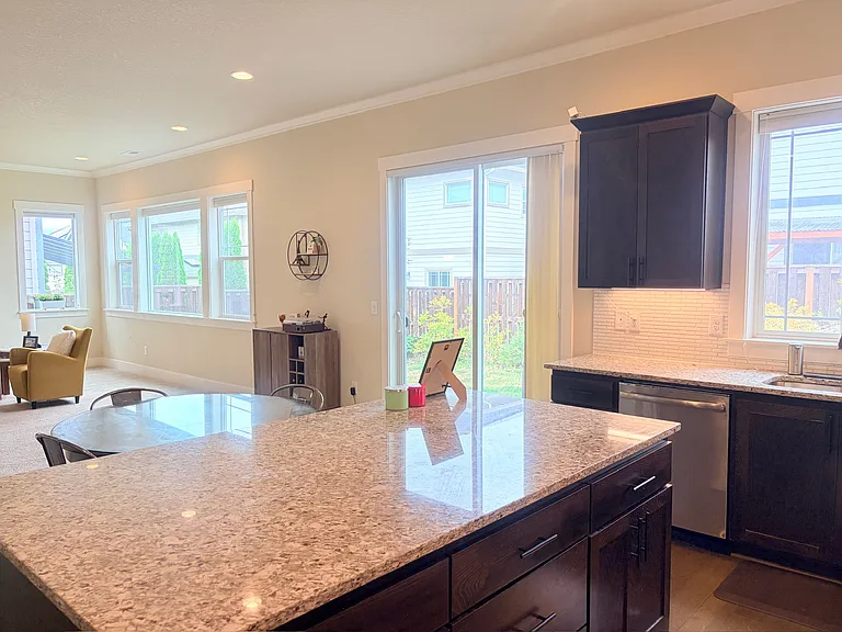 Bright kitchen and dining area with backyard access.