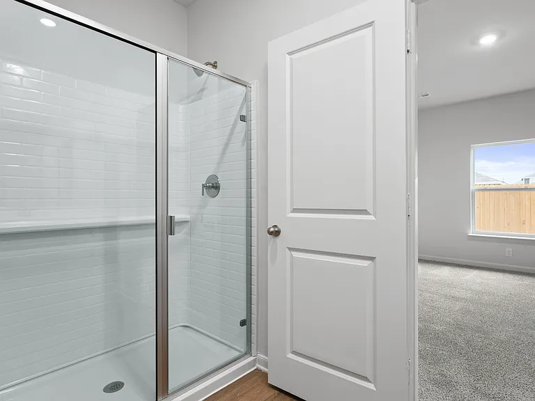 The master bathroom has a walk-in glass shower.