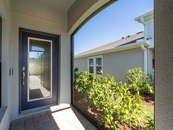 Covered screened entry, with brick pavers to the front door.