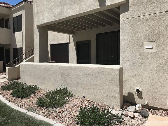 Spacious patio with wrought iron door.