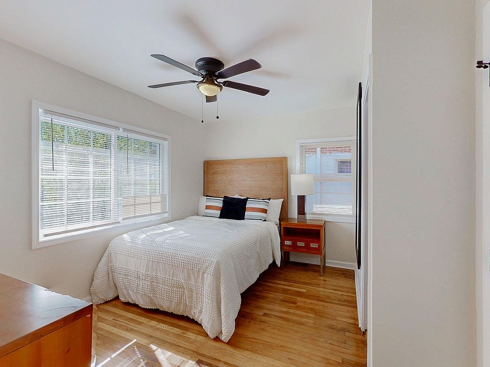 Light-filled room with a queen bed. This room is about 13.5 ft by 10.5 ft.