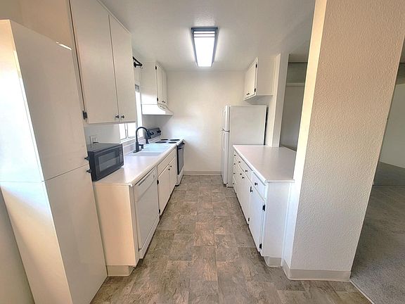 Galley style kitchen with plenty of storage.